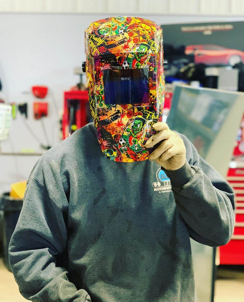 mechanic with welding helmet on